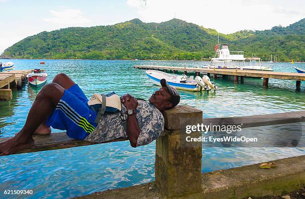 Local man sleeps a the small harbour of the famous carribean beach on August 24, 2016 at Sapzurro, Gulf of Uraba, in Colombia.