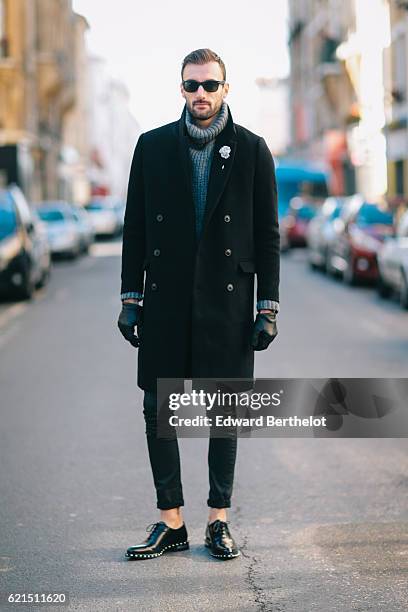 Benjamin Boulay is wearing an H&M black long coat, a Zadig & Voltaire gray turtleneck pull over, The Kooples black denim jeans, Givenchy black shoes,...