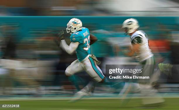 Kenyan Drake of the Miami Dolphins returns a kick for a touchdown during a game against the New York Jets at Hard Rock Stadium on November 6, 2016 in...