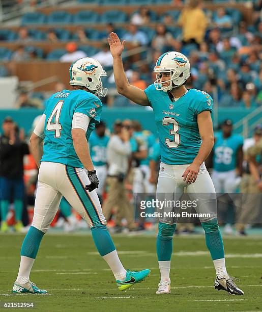 Andrew Franks and Matt Darr of the Miami Dolphins celebrate a field goal during a game against the New York Jets at Hard Rock Stadium on November 6,...