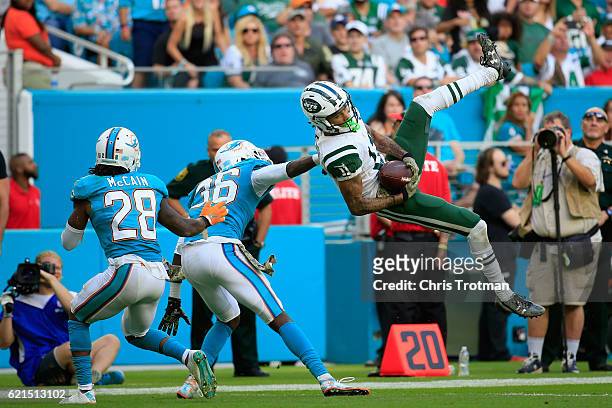 Robby Anderson of the New York Jets goes up for the ball as Tony Lippett of the Miami Dolphins looks on at the Hard Rock Stadium on November 6, 2016...