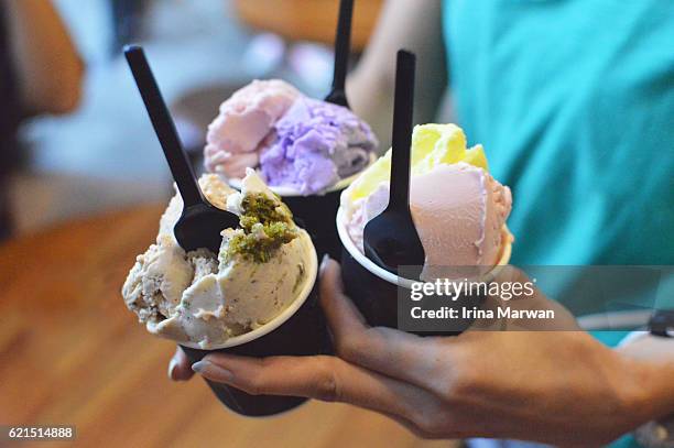women holding multi-flavored gelato - ice cream cup stock-fotos und bilder