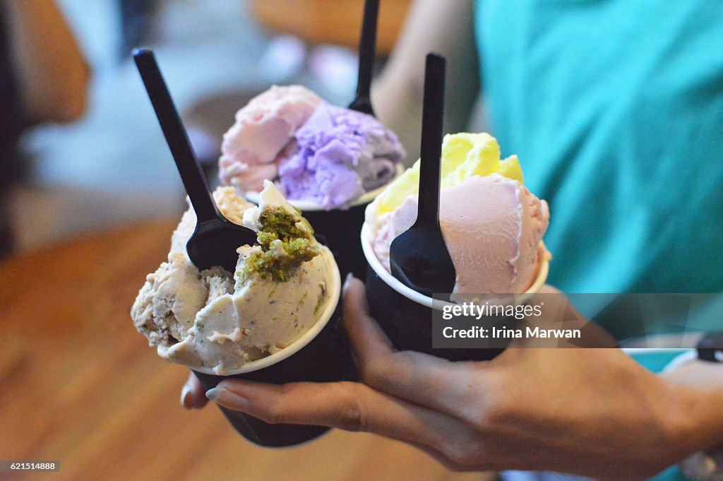 Women Holding Multi-flavored Gelato