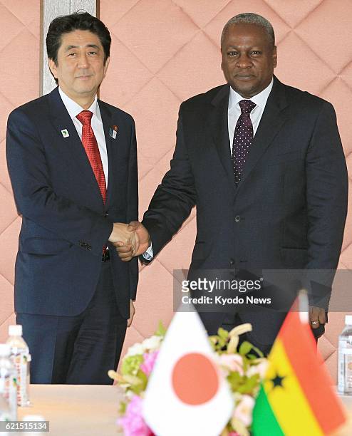 Japan - Japanese Prime Minister Shinzo Abe and Ghana's President John Dramani Mahama shake hands ahead of their talks at a hotel in Yokohama, near...