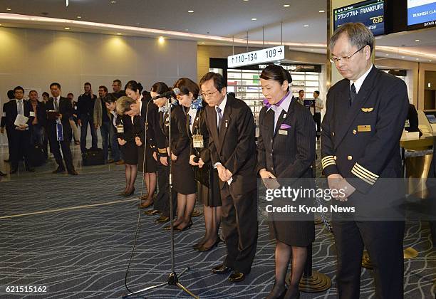 Japan - Osamu Shinobe , president of All Nippon Airways Co., and ANA employees bow to passengers of its flight bound for Frankfurt, using the Boeing...