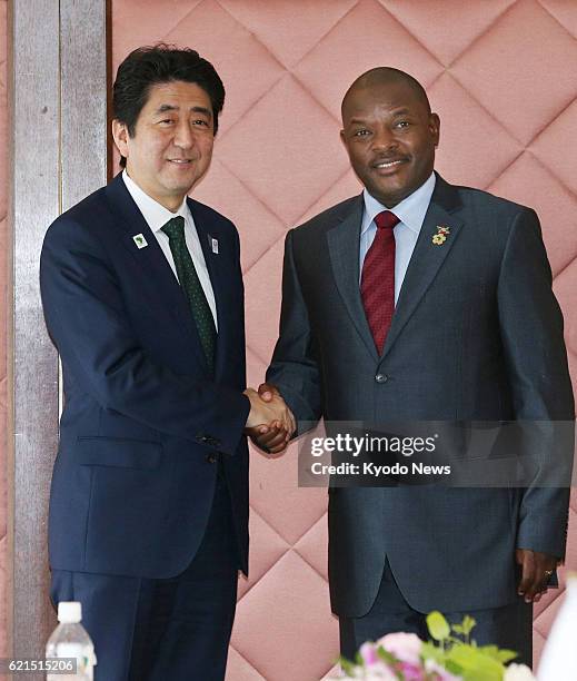 Japan - Japanese Prime Minister Shinzo Abe shakes hands with Burundi President Pierre Nkurunziza at a hotel in Yokohama, near Tokyo, on June 1, 2013.