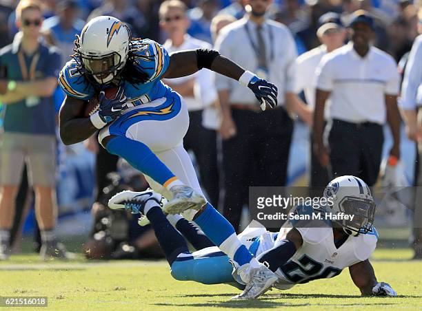 Melvin Gordon of the San Diego Chargers runs past Perrish Cox of the Tennessee Titans in the first half at Qualcomm Stadium on November 6, 2016 in...