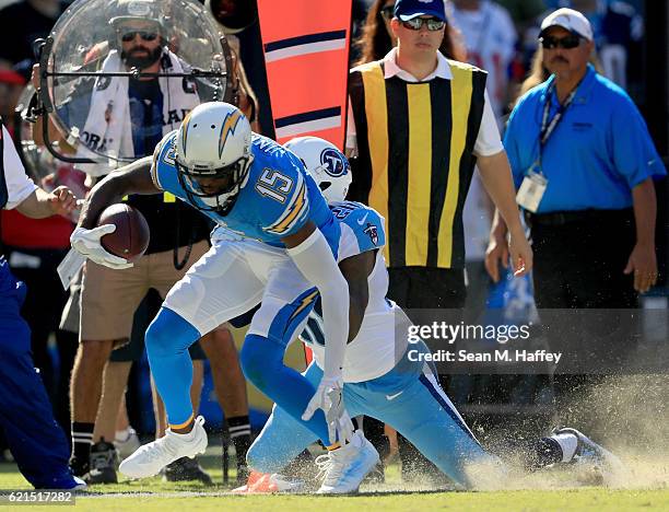 Dontrelle Inman of the San Diego Chargers drags Perrish Cox of the Tennessee Titans to make a first down in the first half at Qualcomm Stadium on...