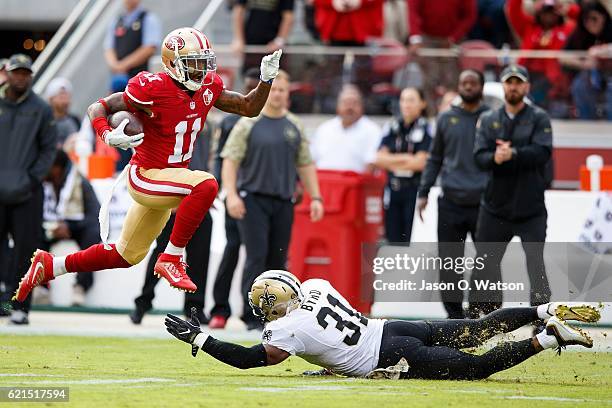 Wide receiver Quinton Patton of the San Francisco 49ers breaks a tackle from free safety Jairus Byrd of the New Orleans Saints during the first...