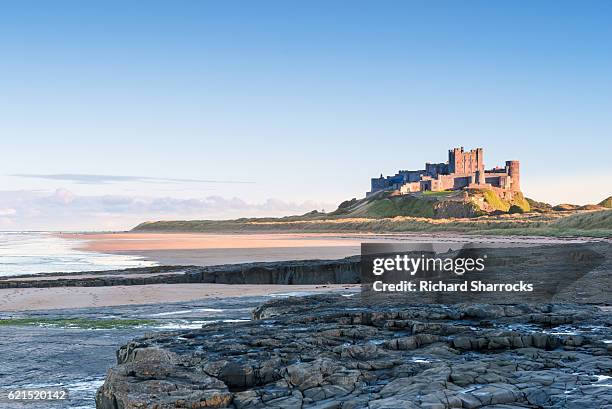 bamburgh castle sunset - bamburgh castle stock pictures, royalty-free photos & images