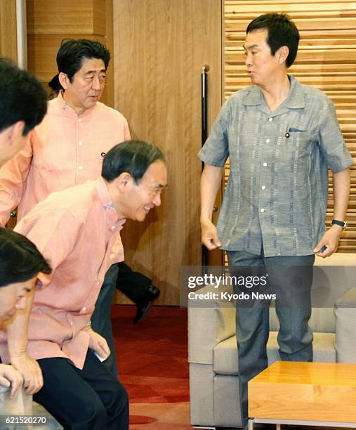 Japan - Prime Minister Shinzo Abe , Environment Minister Nobuteru Ishihara and other ministers attend a Cabinet meeting wearing "kariyushi" -- an...