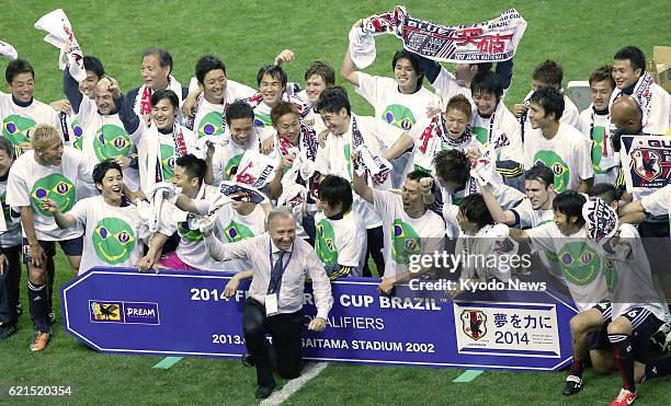 Japan - Japan coach Alberto Zaccheroni and players celebrate after drawing 1-1 with Australia in a World Cup soccer qualifier at Saitama Stadium in...