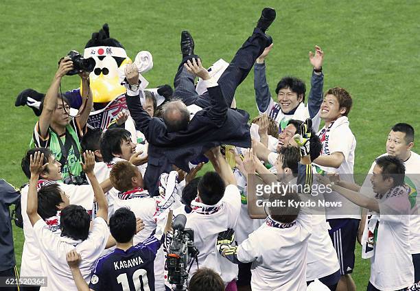 Japan - Japan players toss coach Alberto Zaccheroni into the air in celebration after drawing 1-1 with Australia in a World Cup soccer qualifier at...