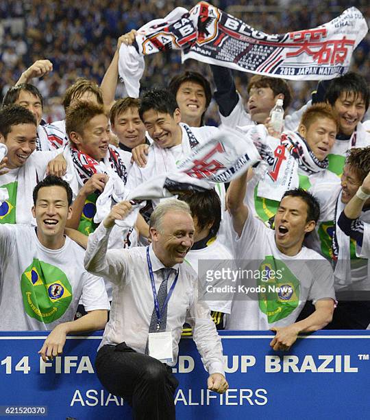 Japan - Japan coach Alberto Zaccheroni and players celebrate after drawing 1-1 with Australia in a World Cup soccer qualifier at Saitama Stadium in...