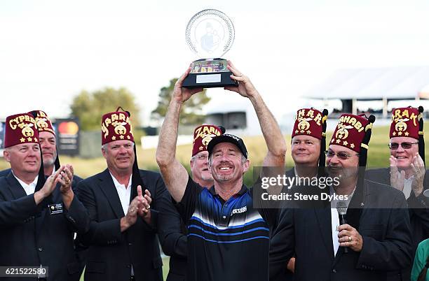 Rod Pampling of Australia celebrates with the winner's trophy after the final round of the Shriners Hospitals For Children Open on November 6, 2016...