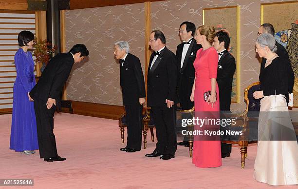 Japan - Japanese Prime Minister Shinzo Abe , accompanied by his wife Akie , exchanges a greeting with Emperor Akihito , ahead of a banquet at the...