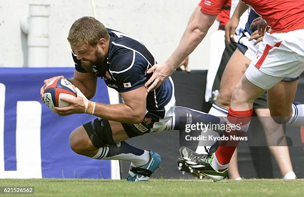 Japan - Michael Broadhurst of Wales scores a try in the first half of the first test-match rugby game against Japan at Hanazono Stadium in Osaka...