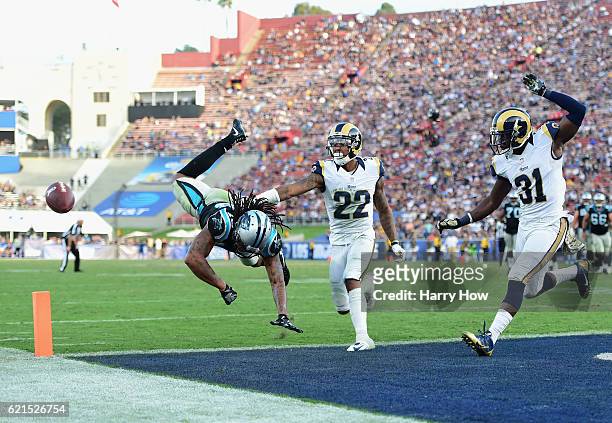 Kelvin Benjamin of the Carolina Panthers misses a catch in front of Trumaine Johnson and Maurice Alexander of the Los Angeles Rams during the fourth...
