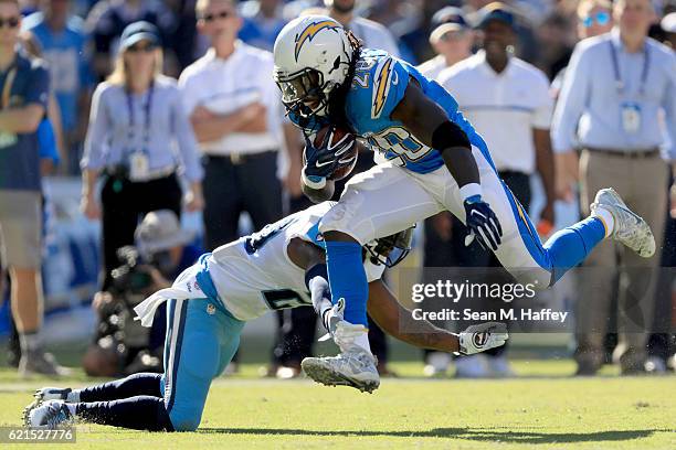 Melvin Gordon of the San Diego Chargers runs past Perrish Cox of the Tennessee Titans in the first half at Qualcomm Stadium on November 6, 2016 in...