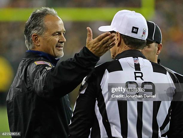 Head coach Chuck Pagano of the Indianapolis Colts agrues with referee Tony Corrente during a game against the Green Bay Packers at Lambeau Field on...