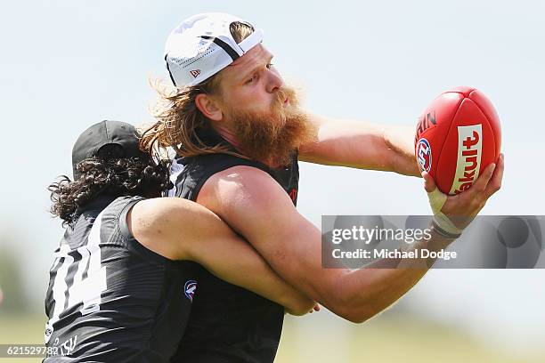 Jake Long of the Bombers tackles Michael Hurley during an Essendon Bomber AFL pre-season training session at True Value Solar Centre on November 7,...