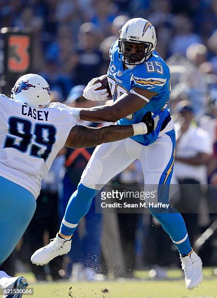 Antonio Gates of the San Diego Chargers breaks a tackle by Jurrell Casey of the Tennessee Titans on a pass play during the first half of a game at...