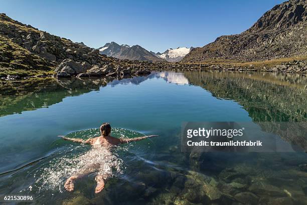 woman swimming in a clear alpine lake - obergurgl stock pictures, royalty-free photos & images