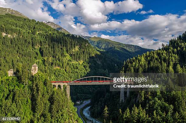 oebb railjet train passing a bridge in tyrol - austria stock pictures, royalty-free photos & images