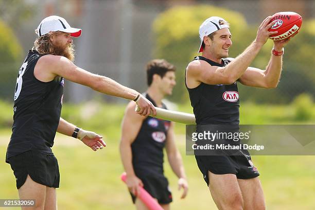 Jobe Watson of the Bombers marks the ball with pressure from Michael Hurley during an Essendon Bomber AFL pre-season training session at True Value...