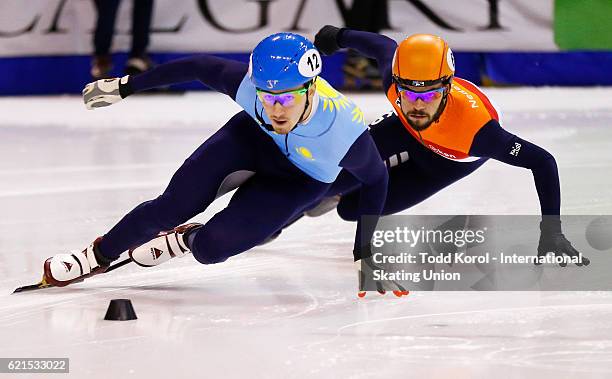 Denis Nikisha of Kazakhstan leads Sjinkie Knegt of the Netherlands in the men's 500 meter semi final during the ISU World Cup Short Track Speed...