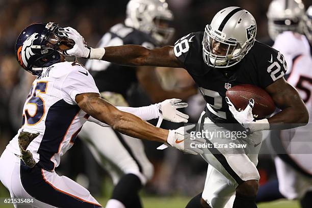 Latavius Murray of the Oakland Raiders carries the ball during the second quarter against the Denver Broncos at Oakland-Alameda County Coliseum on...