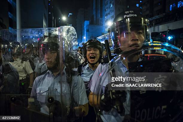 This picture taken on November 6 shows a police officer yelling instructions during a protest against an expected interpretation of the city's...