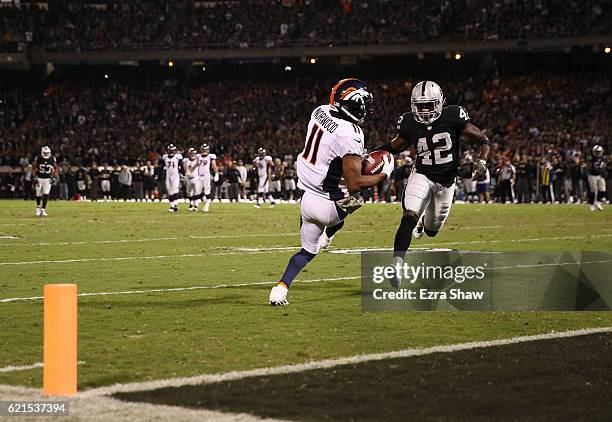 Jordan Norwood of the Denver Broncos catches a touchdown pass from Trevor Siemian during the second quarter against the Oakland Raiders at...