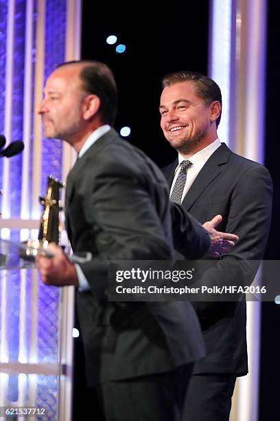 Director Fisher Stevens and producer Leonardo DiCaprio, recipients of the "Hollywood Documentary Award" for "Before The Flood", speak onstage at the...