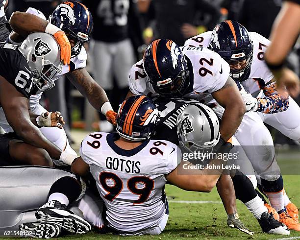 Denver Broncos nose tackle Sylvester Williams Denver Broncos defensive tackle Adam Gotsis stop Oakland Raiders running back DeAndre Washington for no...