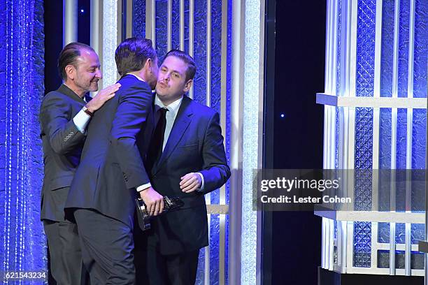 Actor Leonardo DiCaprio and director Fisher Stevens accept the Hollywood Documentary Award for "Before the Flood" from actor Jonah Hill onstage...