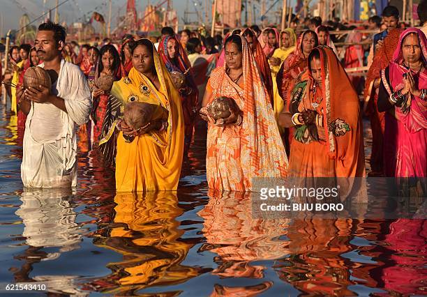 Indian Hindu devotees offer prayers during the Chhath Festival on the banks of the Brahmaputra River in Guwahati on November 6, 2016. The Chhath...