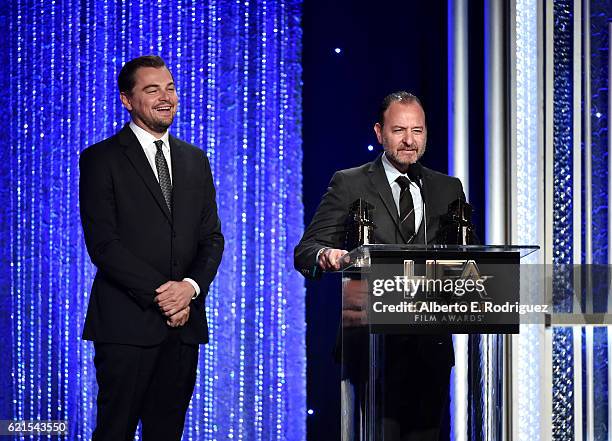 Producer Leonardo DiCaprio and director Fisher Stevens, recipients of the "Hollywood Documentary Award" for "Before The Flood", speak onstage during...