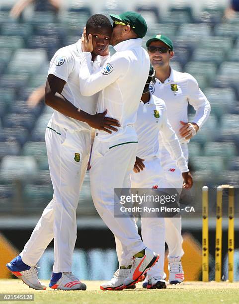 Kagiso Rabada of South Africa is kissed by Faf du Plessis of South Africa after claming his fifth wicket, the wicket of Mitchell Starc of Australia...