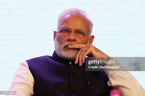 Indian Prime Minister Narendra Modi listens as British Prime Minister Theresa May speaks during the India-U.K. 'Tech Summit' on November 7, 2016 in...