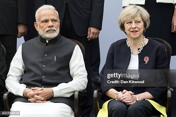 British Prime Minister Theresa May and Indian Prime Minister Narendra Modi pose for a group photograph ahead of the India-U.K. 'Tech Summit' on...