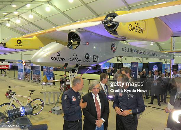 United States - U.S. Energy Secretary Ernest Moniz chats with Bertrand Piccard and Andre Borschberg, the pilots of the Solar Impulse plane, in front...