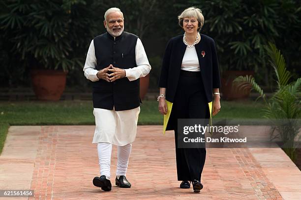 British Prime Minister Theresa May and Indian Prime Minister Narendra Modi walk through the gardens of Hyderabad House, on November 7, 2016 in New...