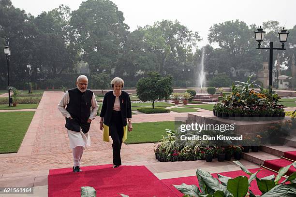 British Prime Minister Theresa May and Indian Prime Minister Narendra Modi walk through the gardens of Hyderabad House, on November 7, 2016 in New...