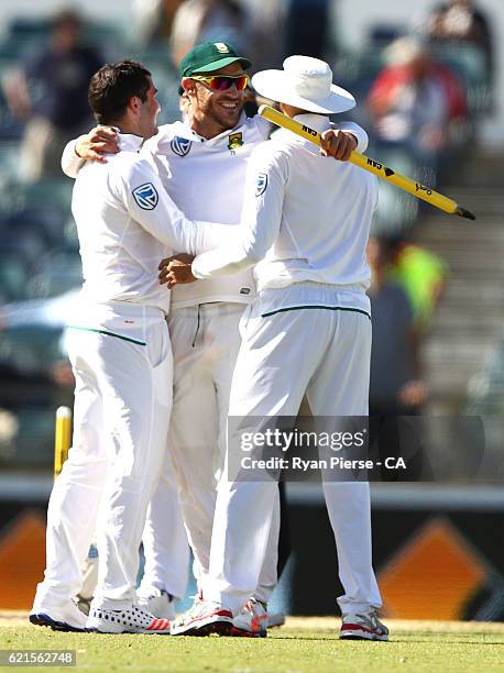 Stephen Cook, Faf du Plessis and Hashim Amla of South Africa celebrate victory after day five of the First Test match between Australia and South...