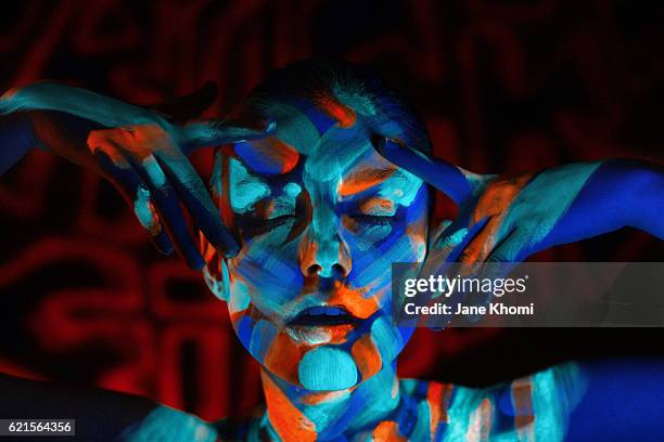 beautiful woman with uv make-up - neon coloured stock-fotos und bilder