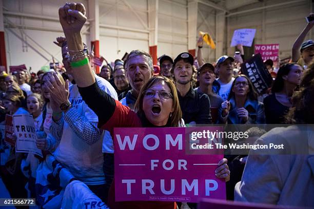 Supporters cheer as Republican presidential candidate Donald Trump speaks during a campaign event at an Atlantic Aviation hanger in Moon Township, PA...