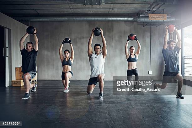 because working out on your own can be a drag... - medicine ball stock pictures, royalty-free photos & images