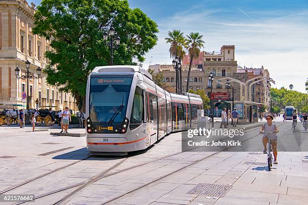 seville trams (light rail) blend with historic city centre - lightrail stock pictures, royalty-free photos & images