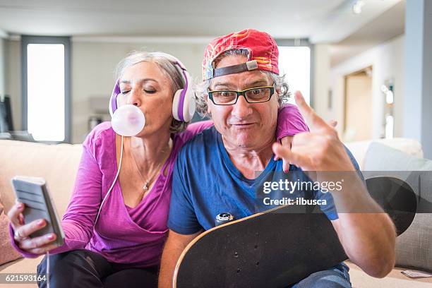 young at heart grandparents series: listening music and rock sign - young at heart bildbanksfoton och bilder